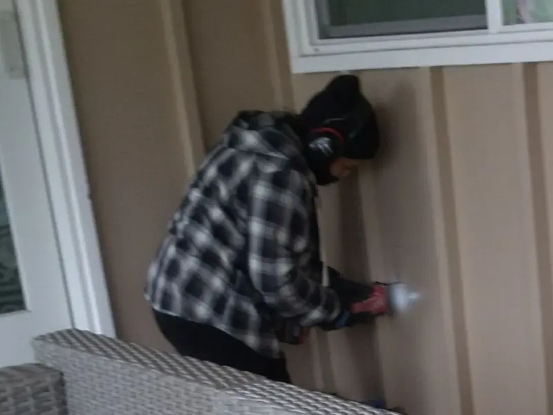 Professional electrician installing an exterior outlet in Princeton